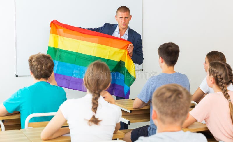 Pupils in classroom listen to teacher who explains what is LGBT. Pupils in classroom listen to the teacher who explains what is LGBT
