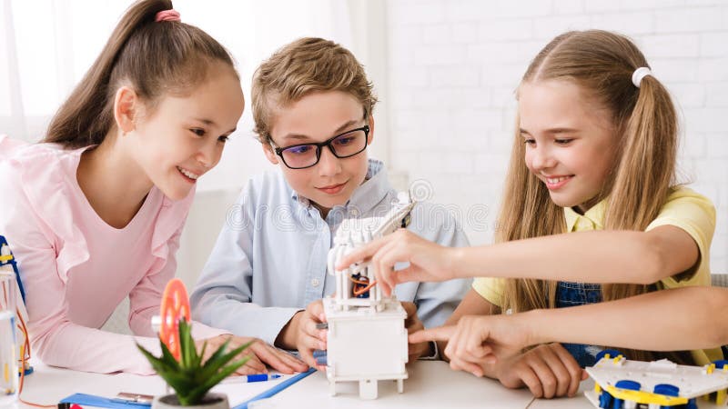 Pupils creating robots together at stem class stock images