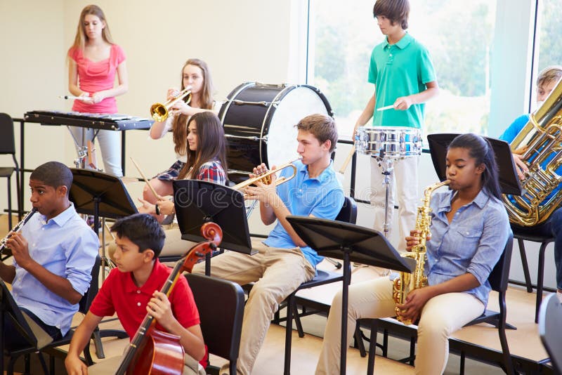 Male Pupil Playing Trumpet In High School Orchestra Stock Photo