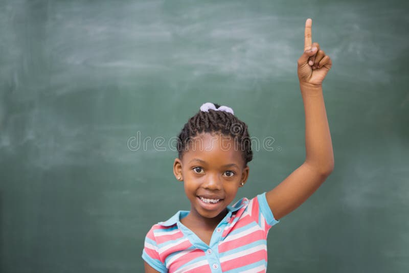 Pupils raising hand in classroom stock photos