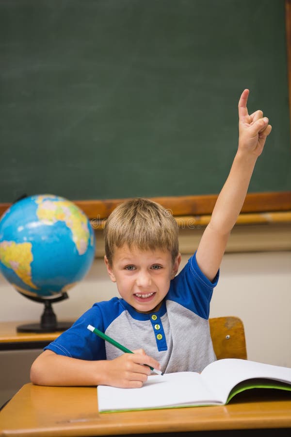 Pupils raising hand in classroom royalty free stock photos