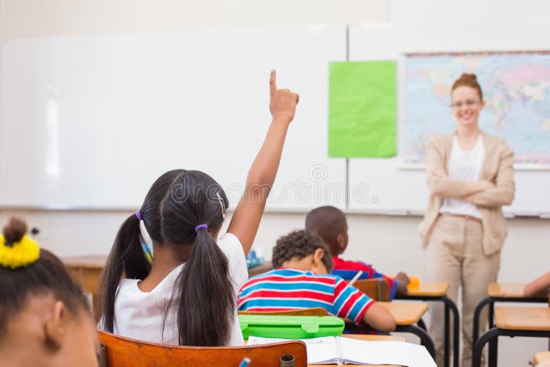 Pupils raising hand during geography lesson in classroom royalty free stock photos
