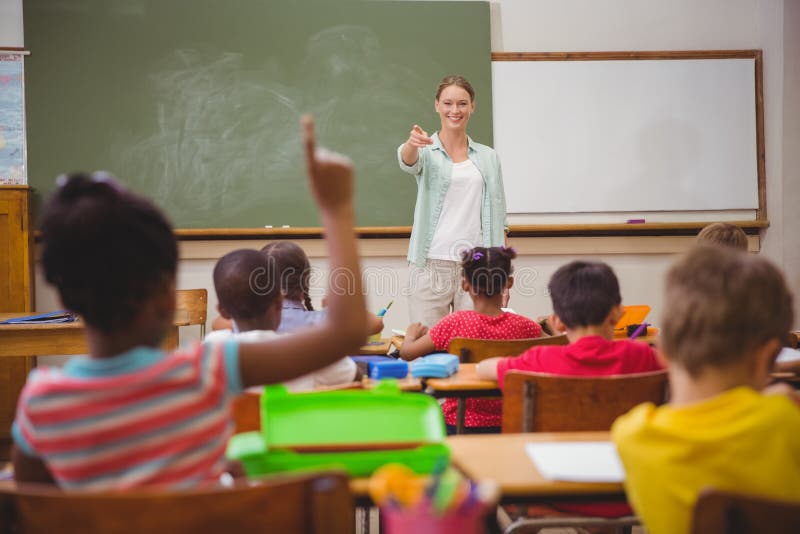 Pupils raising their hands during class stock image