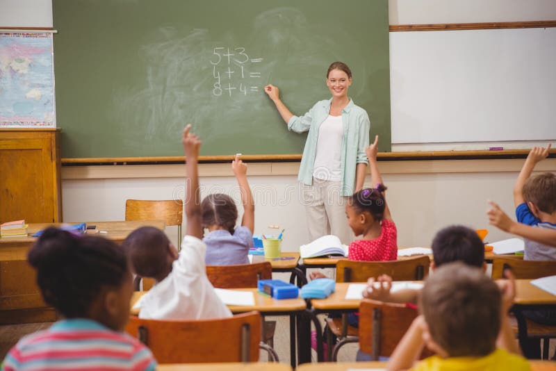 Pupils raising their hands during class stock images