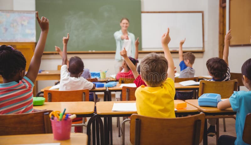 Pupils raising their hands during class royalty free stock image