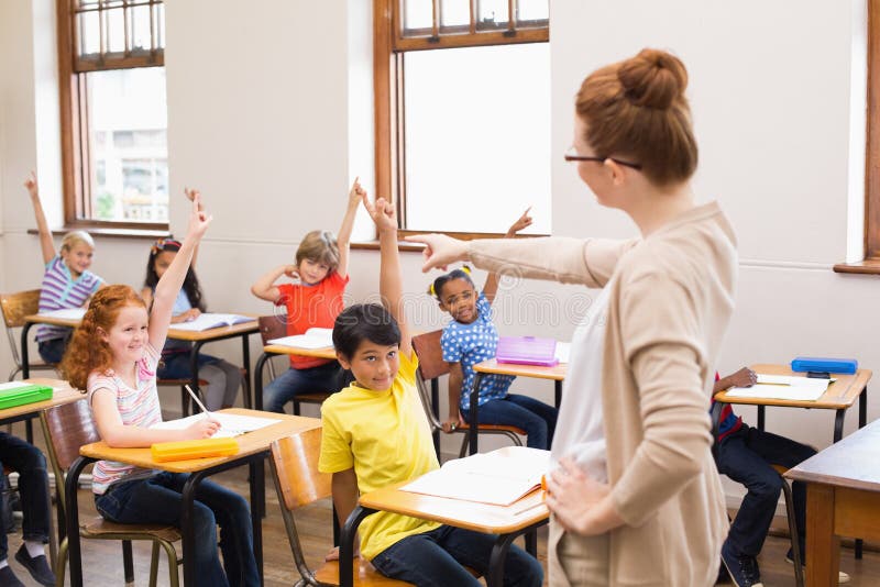 Pupils raising their hands during class royalty free stock images