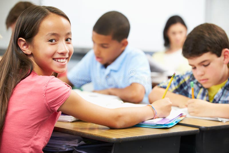 Pupils Studying At Desks In Classroom stock images