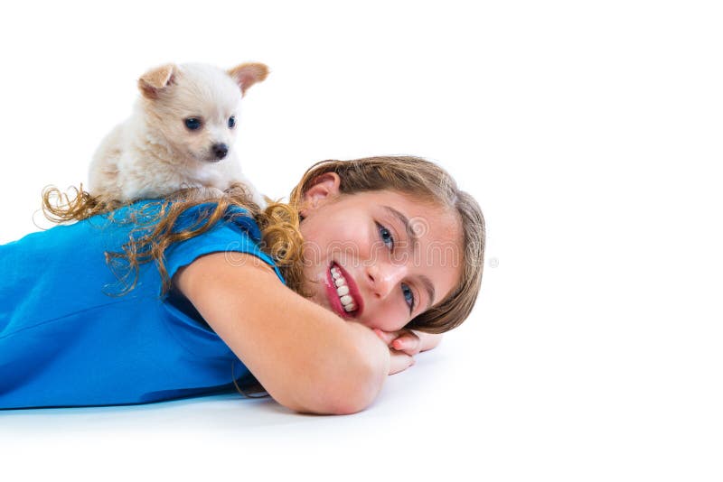Puppy chihuahua dog on kid girl lying happy smiling