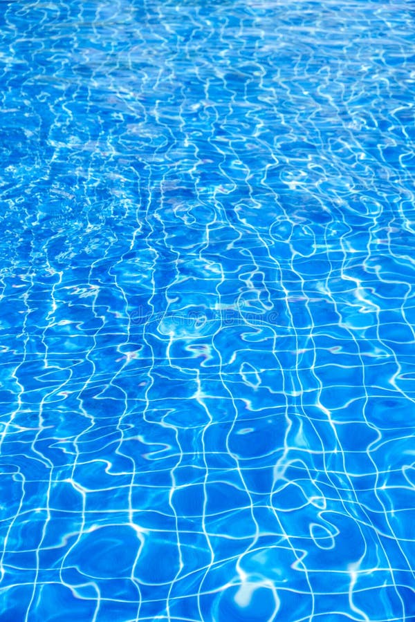 Pure clear ripped blue swimming pool water background , vertical composition