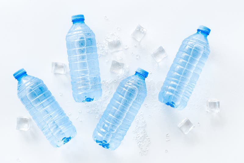 Pure Frozen Water in Plastic Bottles on Blue Background Top View