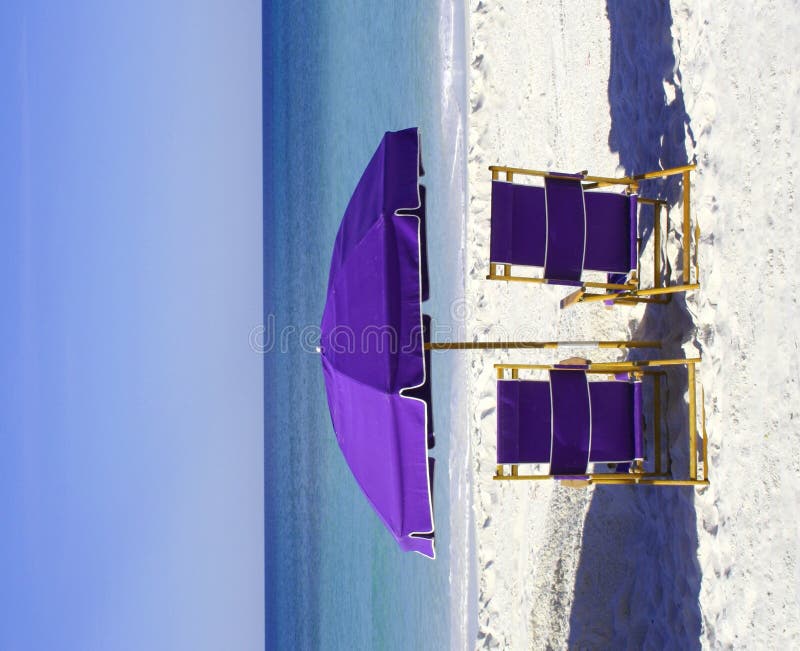 Purple beach chairs and umbrella