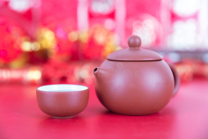 Purple clay milk pot and tea bowl on red background. The Chinese characters in the picture mean `happiness` royalty free stock photo