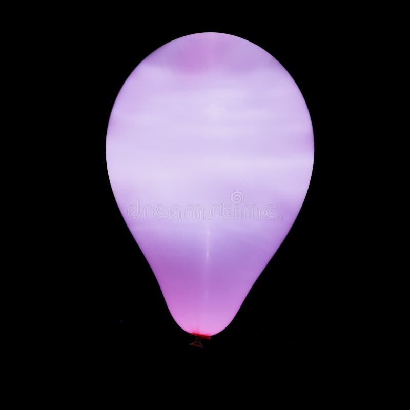 Purple Balloon Illuminated with Intern LED Light Against Dark