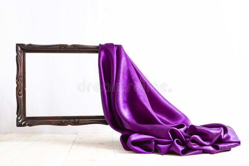 Purple satin curtains unveiling a levitating brown empty frame