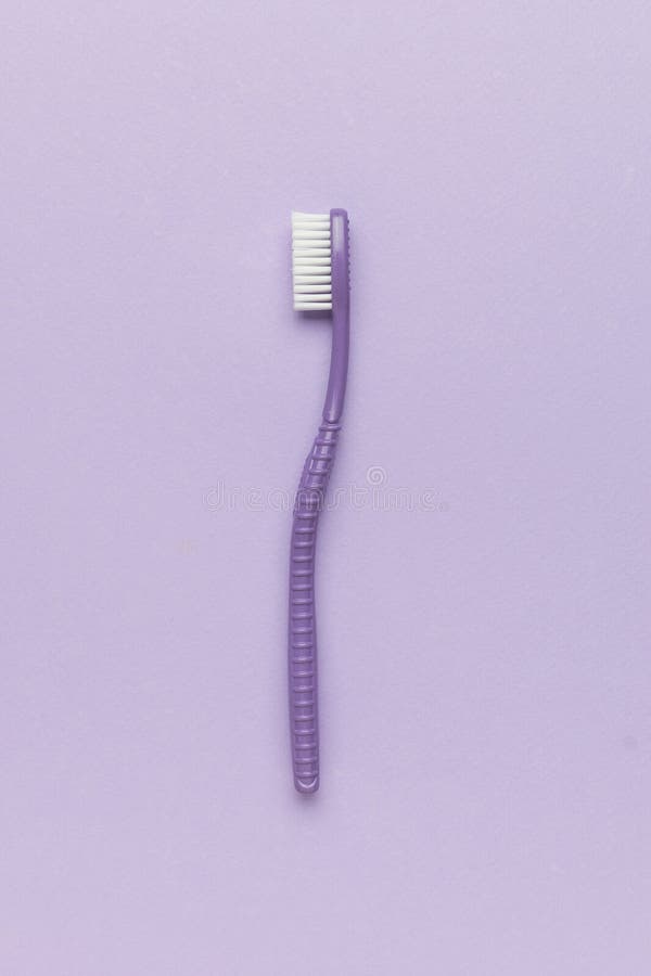 A purple toothbrush on a purple background royalty free stock photos