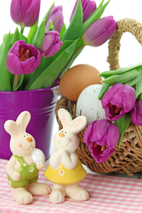 Purple tulips in bucket and two rabbits stock photos