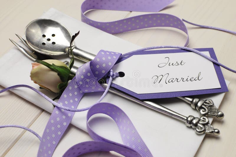 Purple and white shabby chic wedding table setting. Close up.