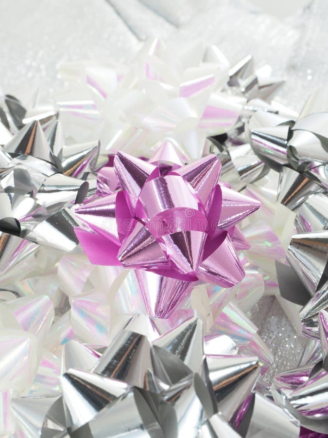 Purple, white and silver bow. On a silver board stock photos Purple, white and silver bow. On a silver board stock photos