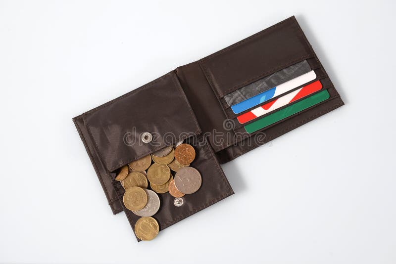 Iron coins of the Russian Federation rubles in a brown purse with plastic cards on a white background. Iron coins of the Russian Federation rubles in a brown purse with plastic cards on a white background