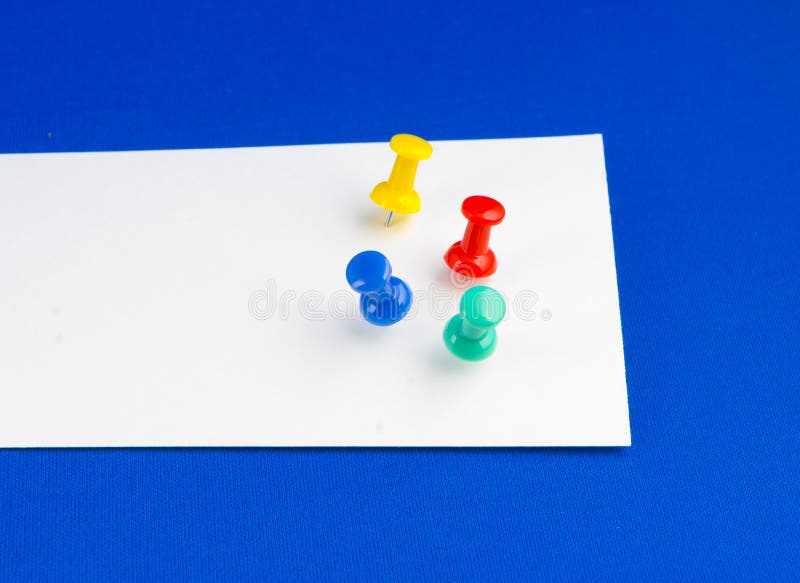 Push pins on white paper.