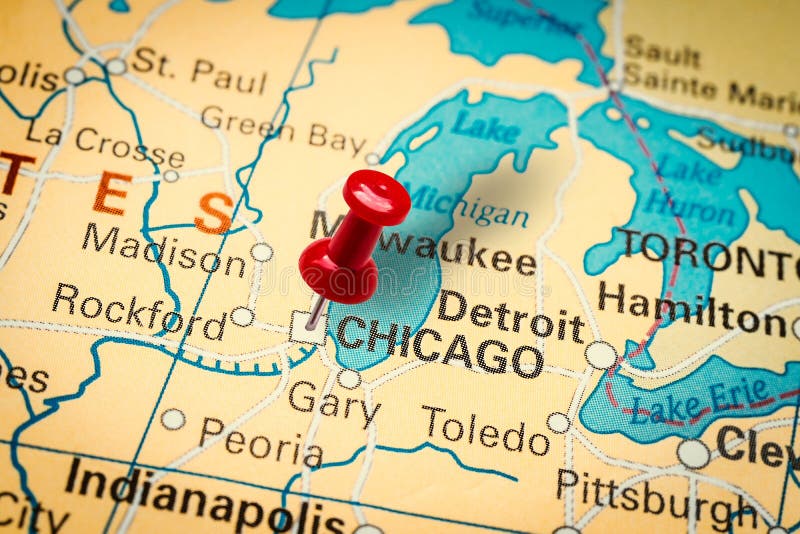 PRAGUE, CZECH REPUBLIC - JANUARY 12, 2019: Red thumbtack in a map. Pushpin pointing at Chicago city in Illinois, America. PRAGUE, CZECH REPUBLIC - JANUARY 12, 2019: Red thumbtack in a map. Pushpin pointing at Chicago city in Illinois, America