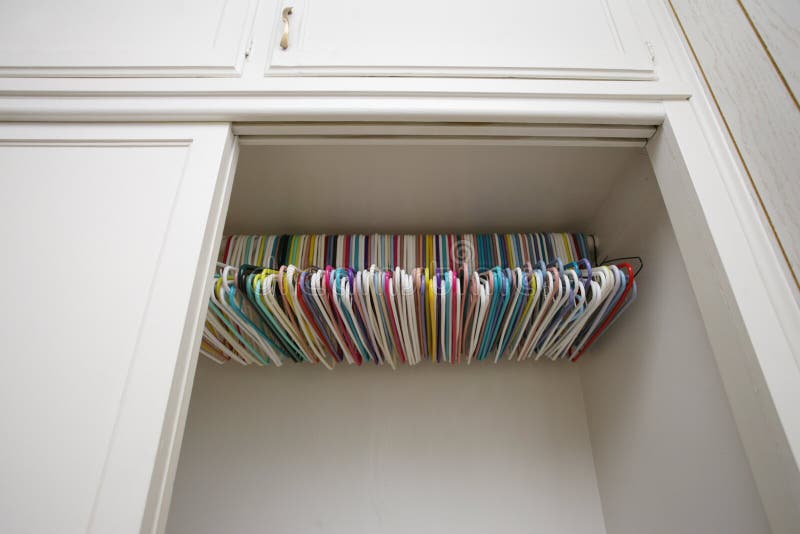 Colorful hangers in empty white closet. Colorful hangers in empty white closet