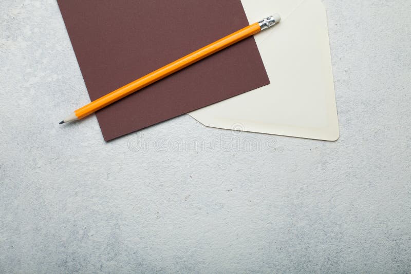 Pusty brązu kwadrata kawałek papieru, beżowa koperta i ołówek na rocznika bielu tle, Opr??nia przestrze? dla teksta zdjęcia royalty free Pusty brązu kwadrata kawałek papieru, beżowa koperta i ołówek na rocznika bielu tle, Opr??nia przestrze? dla teksta zdjęcia royalty free