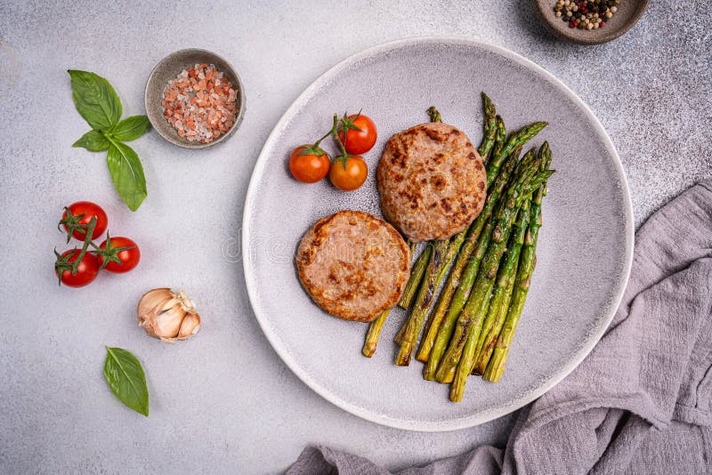 Putenburgern oder -haltern, gegrillt, grüner Spargel lizenzfreie stockfotos