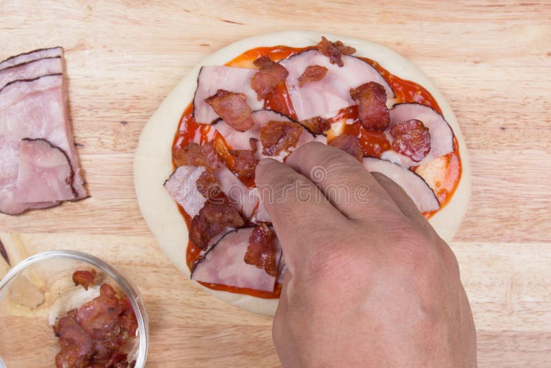 Putting Bacon on Pizza Crust Stock Photo - Image of food, kitchen: 76693052