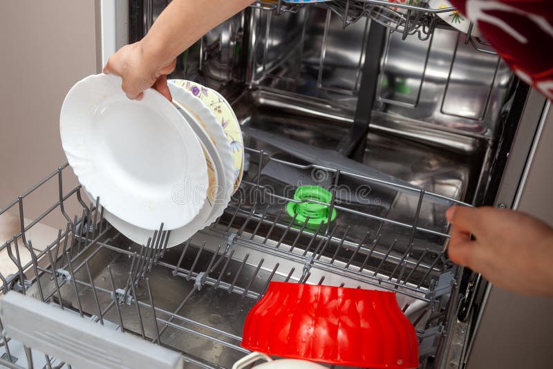 Putting Dishes in Dishwasher Stock Photo Image of vacuum, person