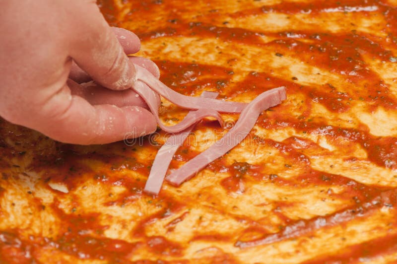 Putting ham on the pizza stock image. Image of pastry 24631933
