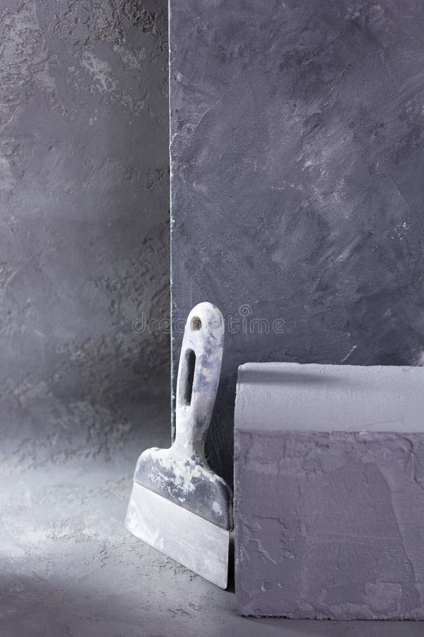 Putty Knife Tool on Cement Background. Construction Tools on Concrete