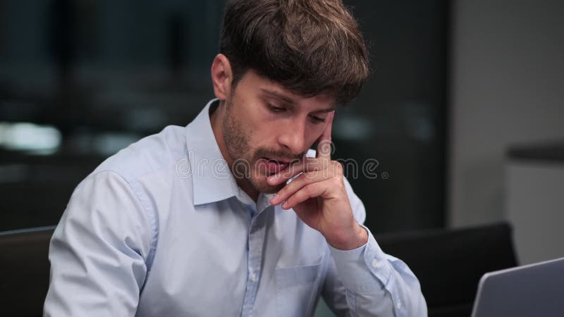 Portrait of a puzzled businessman working in the office with a laptop stock video footage