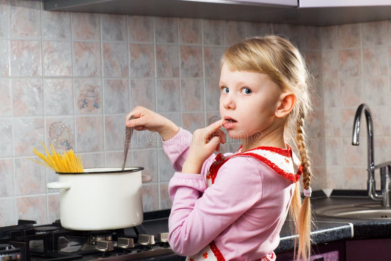 Puzzled girl cooking in the kitchen