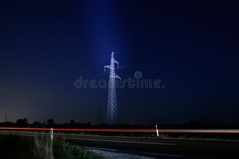 Pylon for electricity distribution at night with starry sky. Red pylons stock images, royalty-free photos and pictures