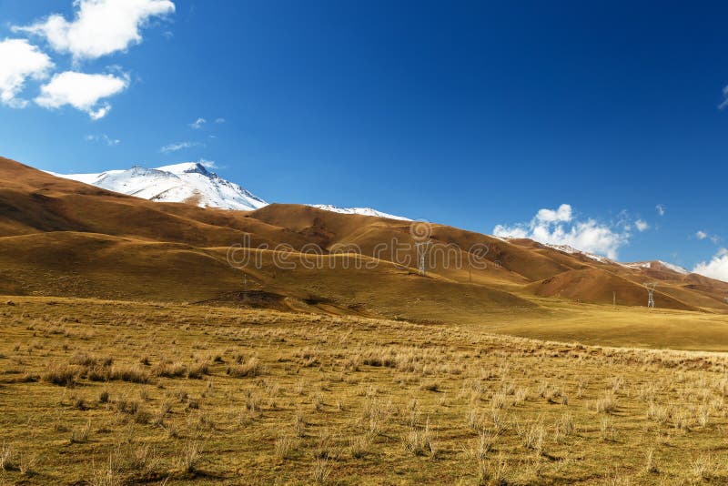 Pylons of high-voltage power lines in the mountains stock photos