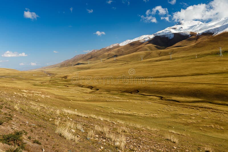 Pylons of high-voltage power lines in the mountains stock photos