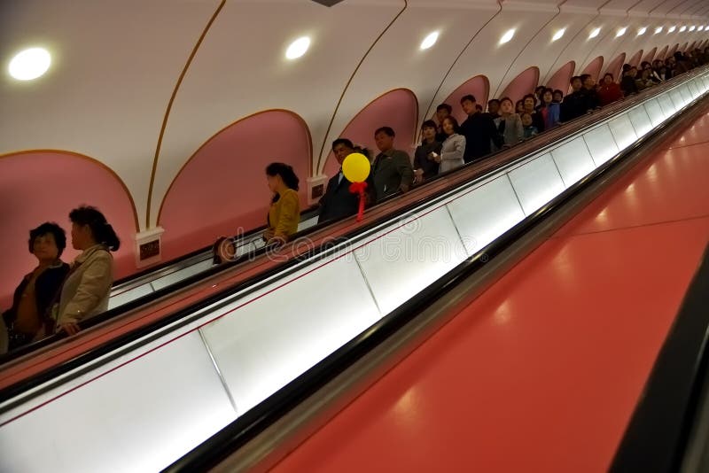 Pyongyang, North Korea. People at Metro station. Pyongyang, North Korea - May 1, 2019: People go down the escalator to the platform of the Kaeson subway station stock images Pyongyang, North Korea. People at Metro station. Pyongyang, North Korea - May 1, 2019: People go down the escalator to the platform of the Kaeson subway station stock images