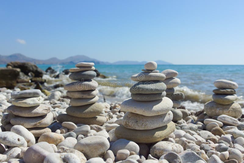 Pyramid of pebbles on a sea beach. royalty free stock photography