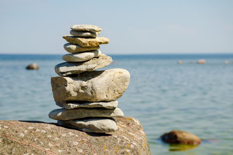 Pyramid of stones on the shore of the blue sea. royalty free stock photography Pyramid of stones on the shore of the blue sea. royalty free stock photography
