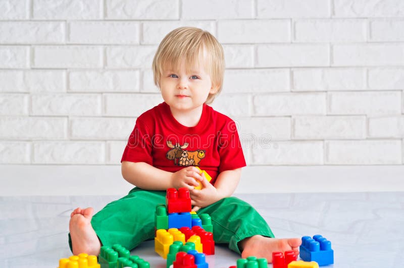 Kid playing with colorful constructor blocks. Kid playing with colorful constructor blocks