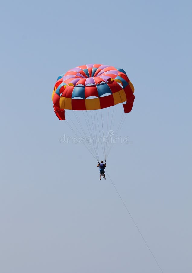 Colorful parachute on a blue sky at the summertime. Colorful parachute on a blue sky at the summertime