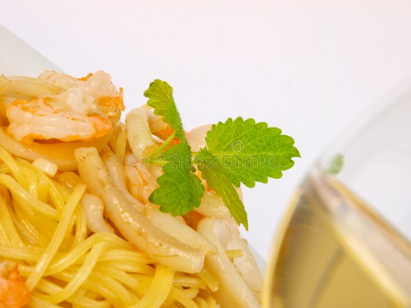 Seafood pasta with white wine. Close up on white background. Seafood pasta with white wine. Close up on white background