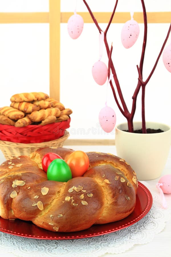 Easter sweet bread with multicolored eggs and shortbread cookies. Easter sweet bread with multicolored eggs and shortbread cookies