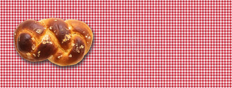 Sweet bread, easter tsoureki, cozonac on red checkered tablecloth background. Braided brioche, festive traditional challah. Banner, copy space. Sweet bread, easter tsoureki, cozonac on red checkered tablecloth background. Braided brioche, festive traditional challah. Banner, copy space