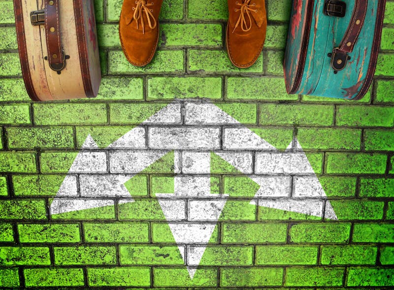 Man feet in suede boots. Vintage suitcases stand on paving stone green road. White arrows point  three different directions. Three option to make decision which way to go. Top view. Minimalist image. Man feet in suede boots. Vintage suitcases stand on paving stone green road. White arrows point  three different directions. Three option to make decision which way to go. Top view. Minimalist image