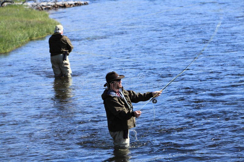 Two fishermen in lake fly fishing in the morning. Two fishermen in lake fly fishing in the morning