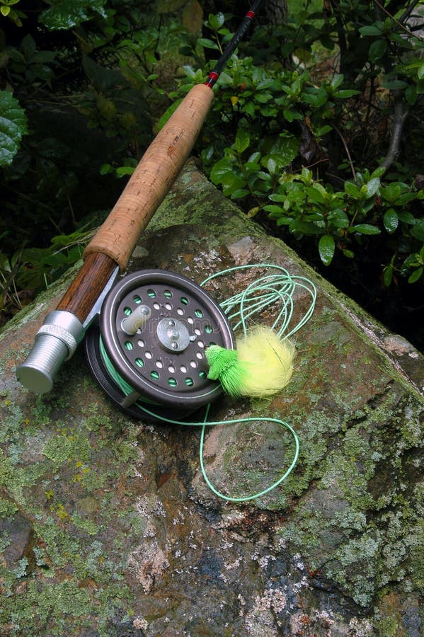 Fly fishing equipment with green and yellow popping bug. Fly fishing equipment with green and yellow popping bug.