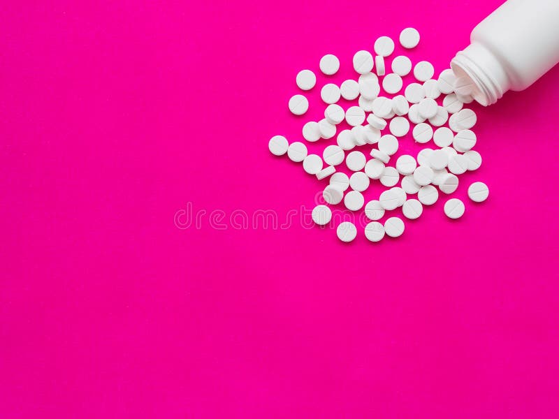 White pills spilling out of a white pill bottle. Healthy and medical concept. White pills spilling out of a white pill bottle. Healthy and medical concept.