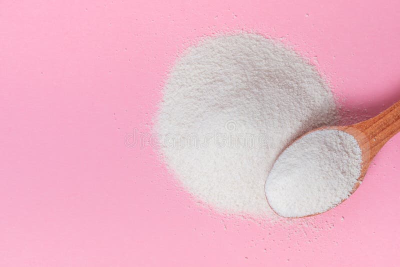 Flat lay of natural collagen powder and spoon over pink background, concept of cosmetic skin care, copy space. Flat lay of natural collagen powder and spoon over pink background, concept of cosmetic skin care, copy space